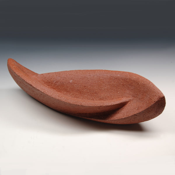 Red sculpture with two interconnected curvaceous wings