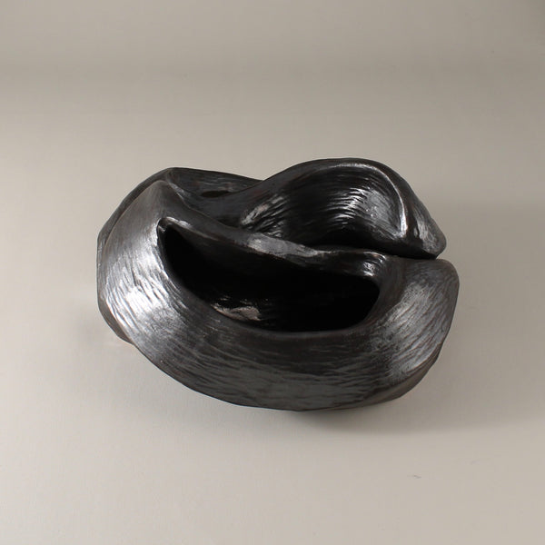 Pewter glazed ceramic sculpture with two nestled organic forms with openings