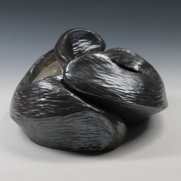Pewter glazed ceramic sculpture with two nestled organic forms with openings