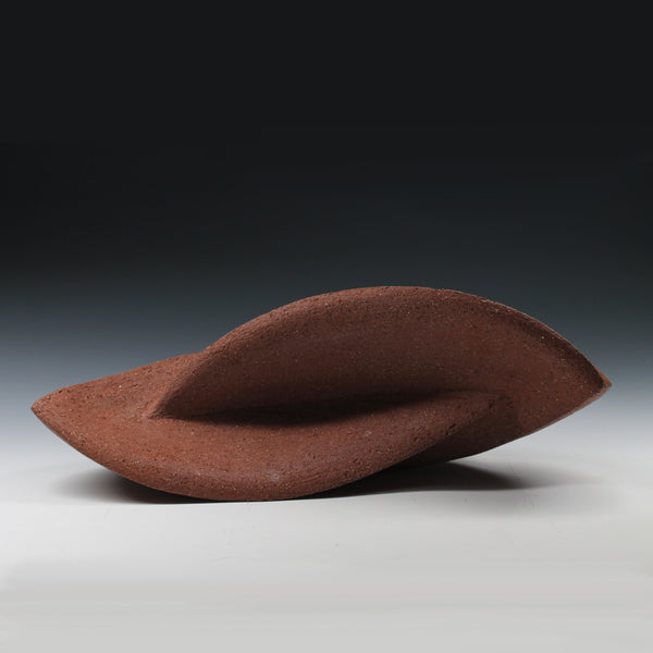 Red sculpture with two interconnected curvaceous wings