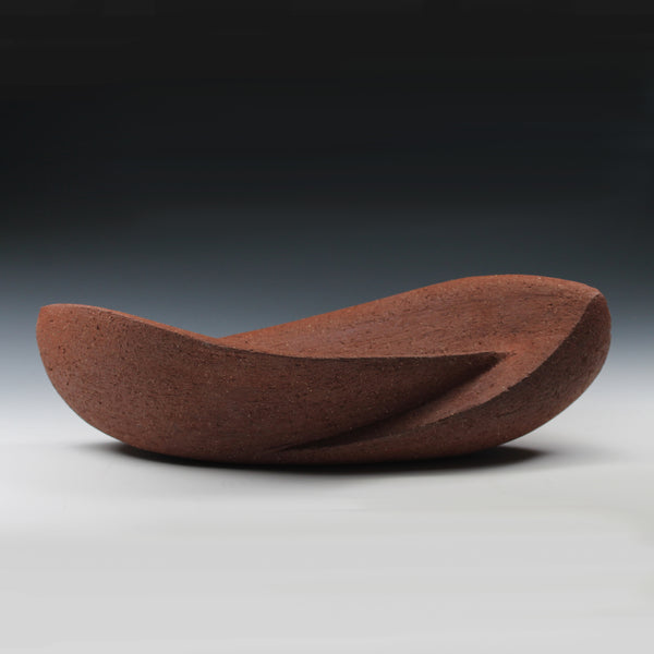 Red sculpture with two interconnected curvaceous wings