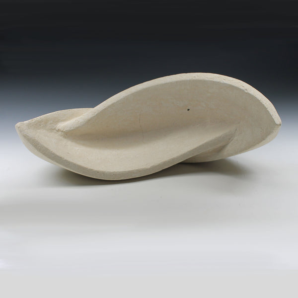 White sculpture with two interconnected curvaceous wings