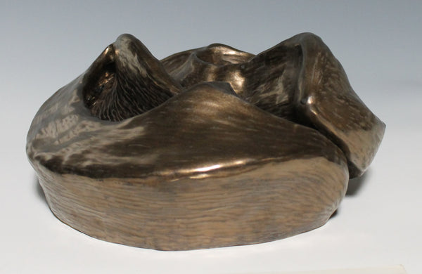 Gold glazed ceramic sculpture with two nestled organic forms with openings