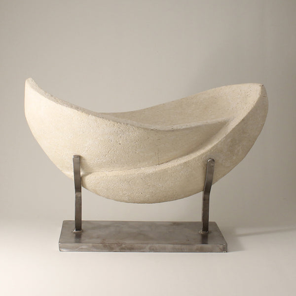 White sculpture with two interconnected curvaceous wings resting on a custom metal stand
