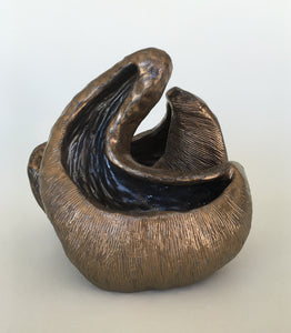 Medium ceramic sculpture with two nestled forms with openings