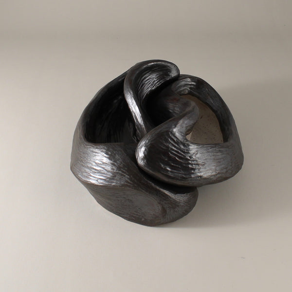Pewter glazed ceramic sculpture with two nestled organic forms with openings