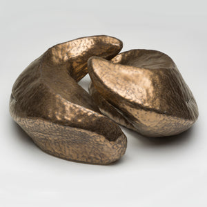 Gold glazed ceramic sculpture with two nestled organic forms